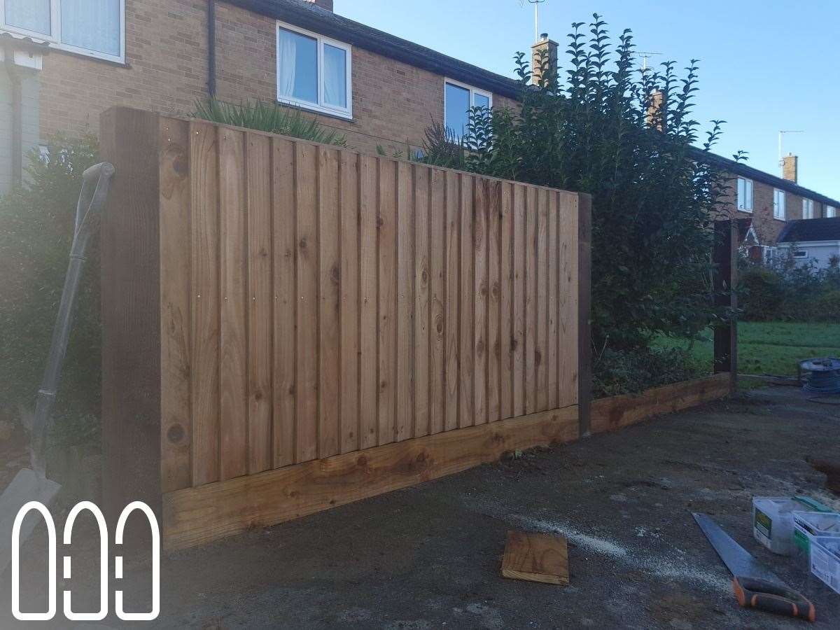 Close board fencing with wooden posts and gravel boards