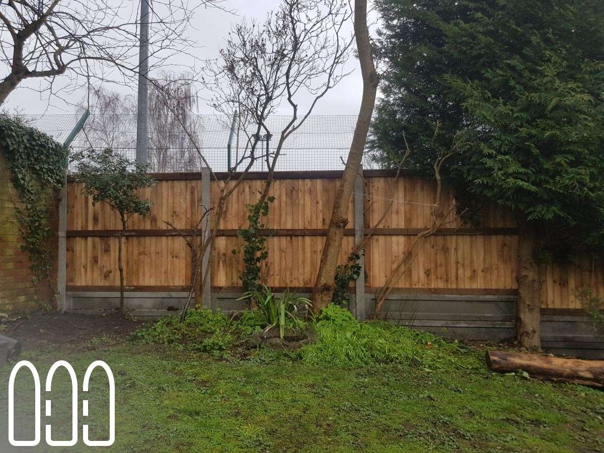 Close board fencing with concrete posts and gravel boards