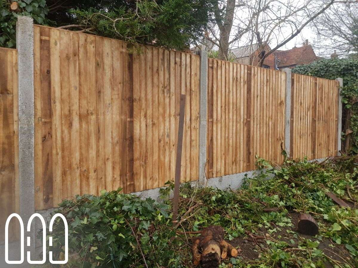 Close board fencing with concrete posts and gravel boards