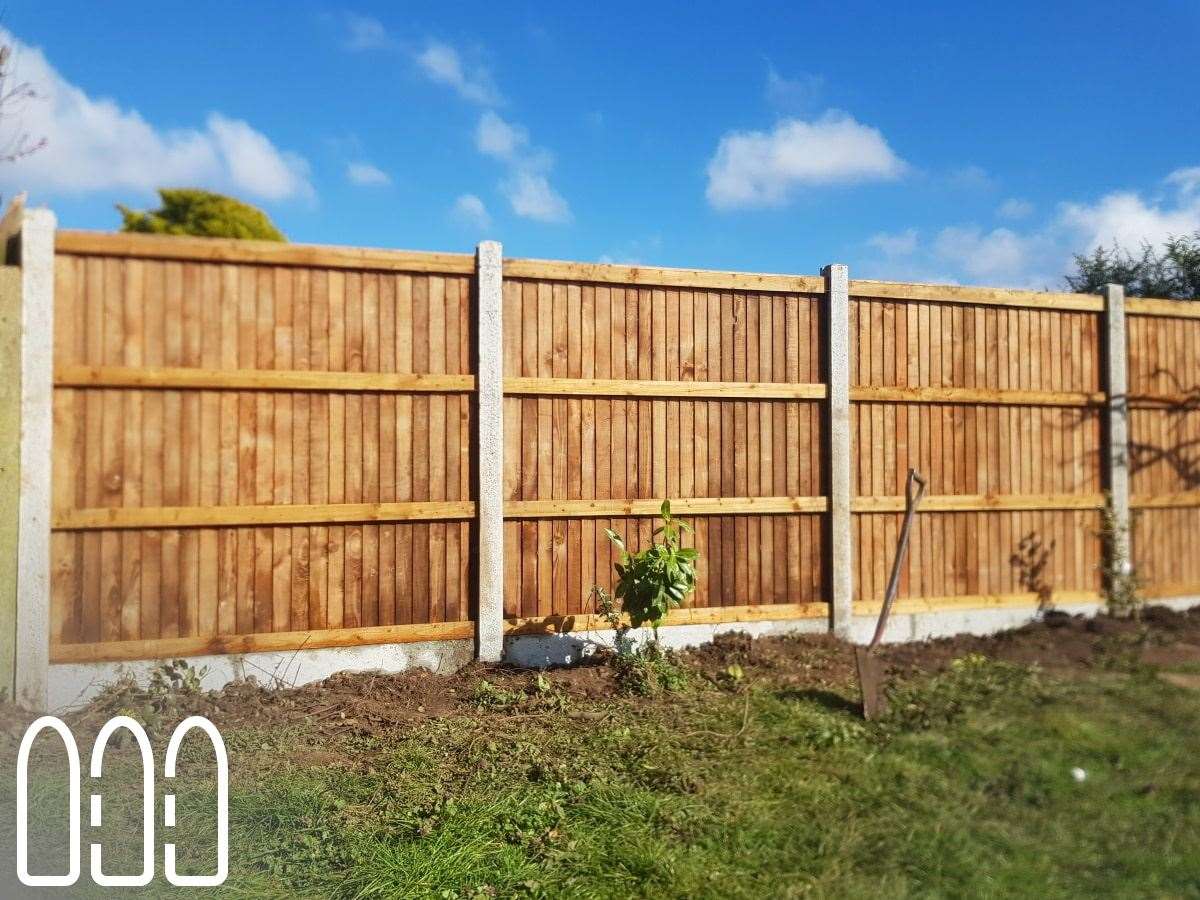 Close board fencing with concrete posts and gravel boards