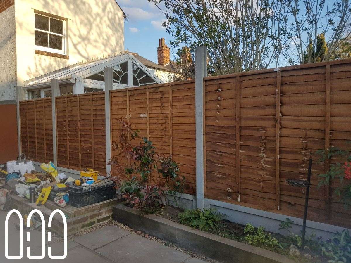 Grange waney fencing with concrete posts, gravel boards and a diamond trellis