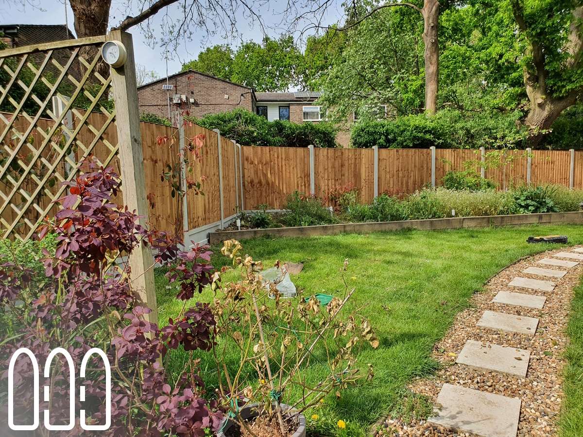 Close board fencing with concrete posts and gravel boards and a diamond trellis.