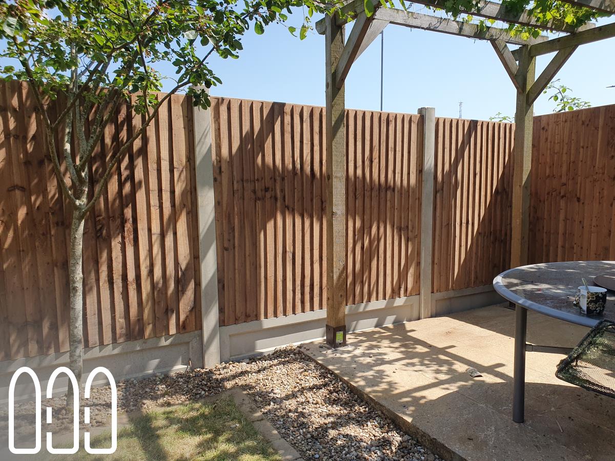 Installation of a new fence built from concrete posts, concrete gravel boards and close board feather edge fence panels.