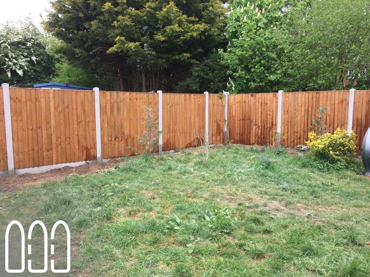 Close board fencing with concrete posts and gravel boards