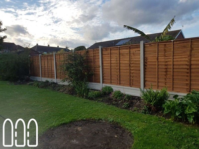 Waney fencing with concrete posts and gravel boards