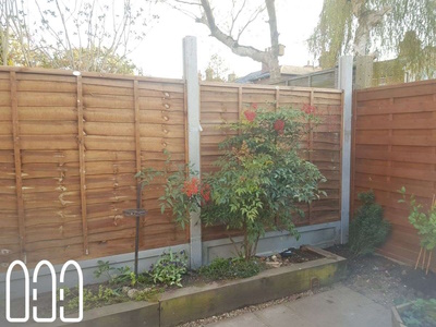 Grange waney fencing with concrete posts, gravel boards and a diamond trellis