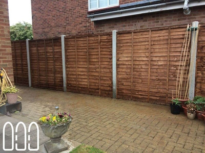 Waney fencing with concrete posts